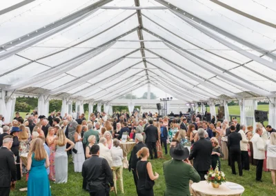 Social event under tent at Great Meadow